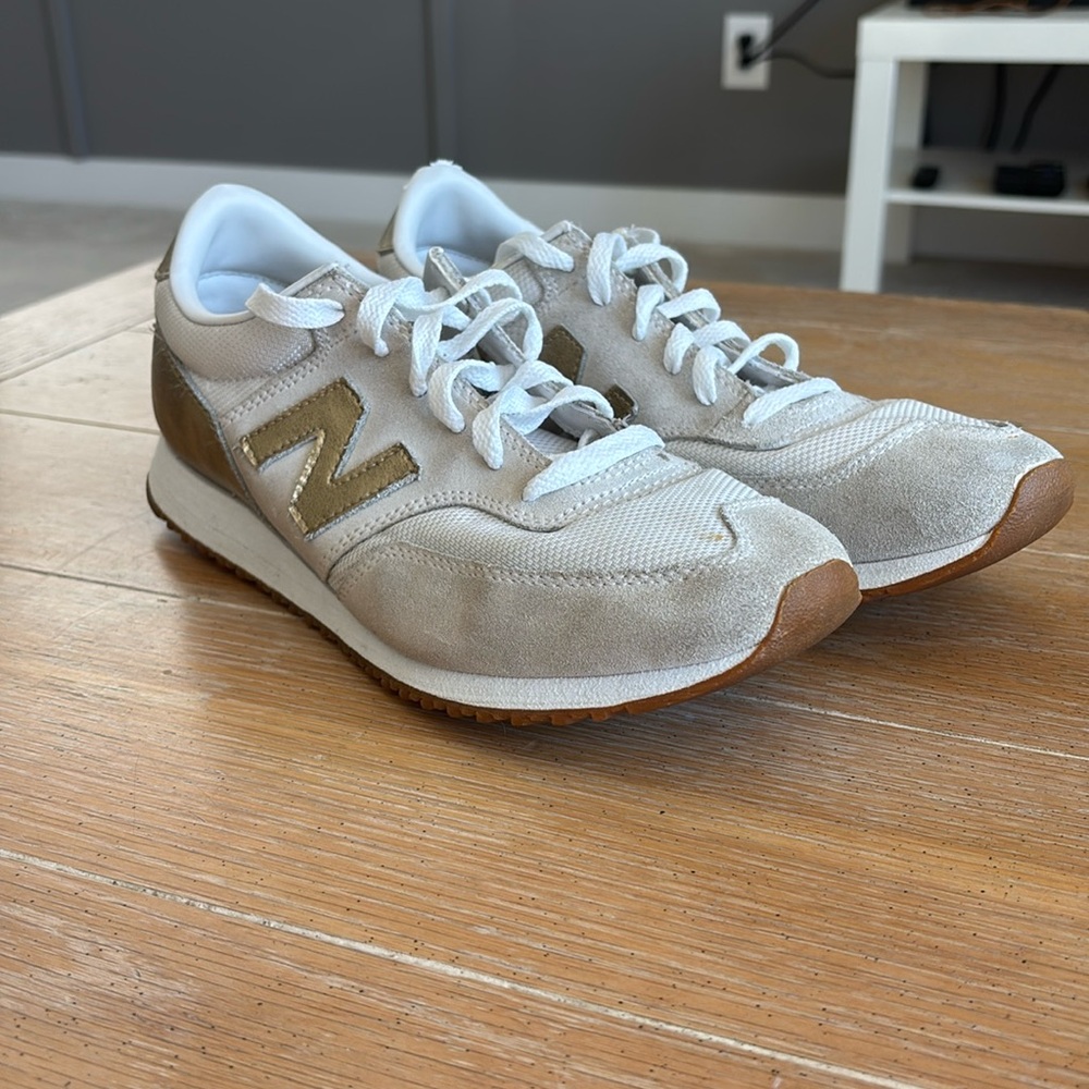 gold and cream new balance athletic shoes